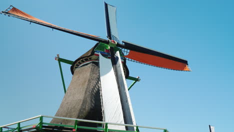 an old dutch windmill against the background of the blue sky 4k video