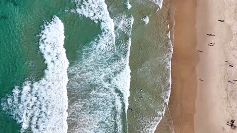 aerial view of waves and sandy beach