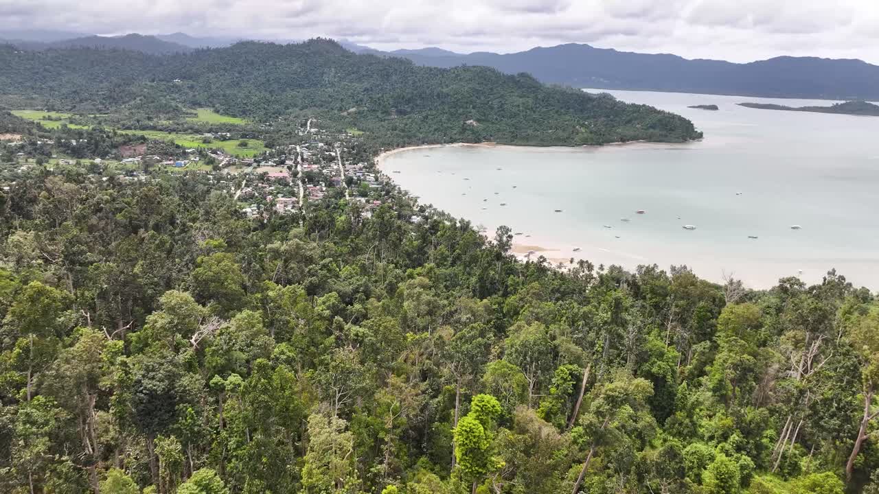 Port Barton settlement over trees. Travel destination in Philippines, exotic getaway. Drone