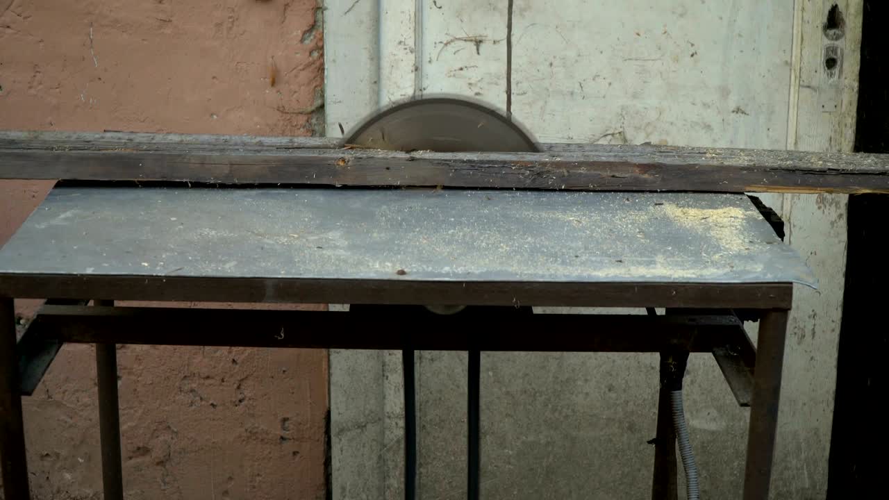 sierra circular. el mago corta una tabla de madera en una sierra circular, primer plano.