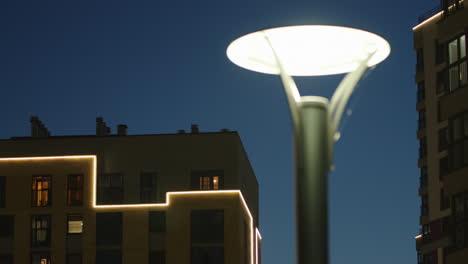 night view of modern apartment buildings with streetlamp