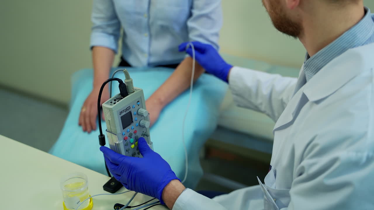 Doctor examines female patient reflex. Doctor scanning hand of female patient at office