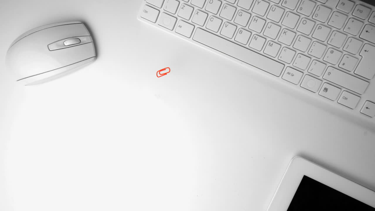 Paperclip falling in the middle of an office desk