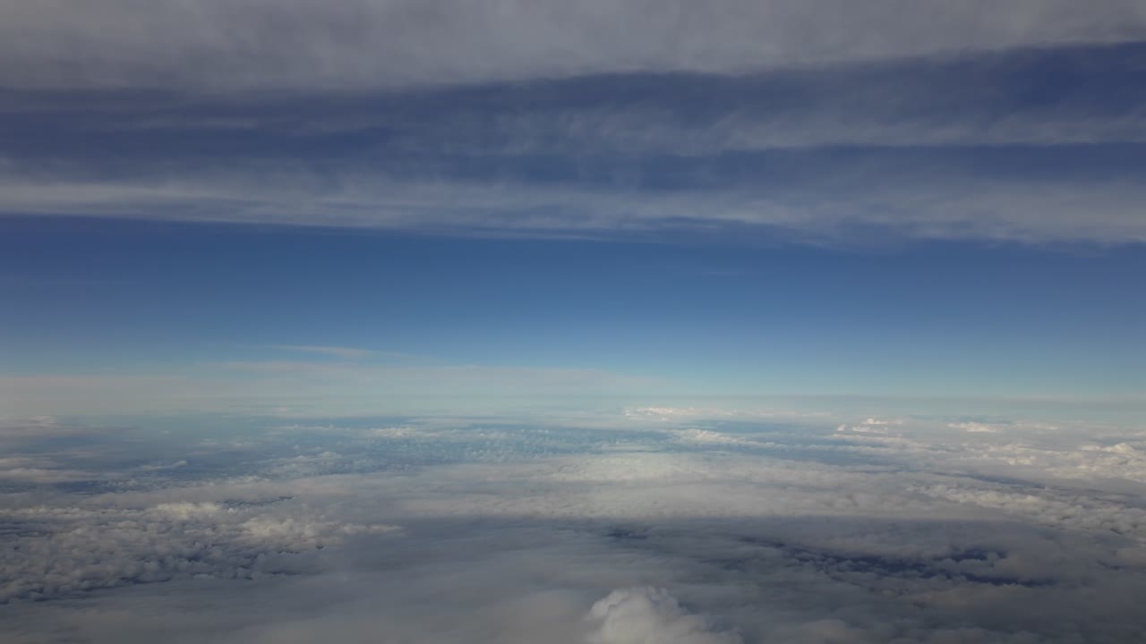 POV flying between layers of ethereal stratus clouds at supersonic speed, taken from a jet cockpit.