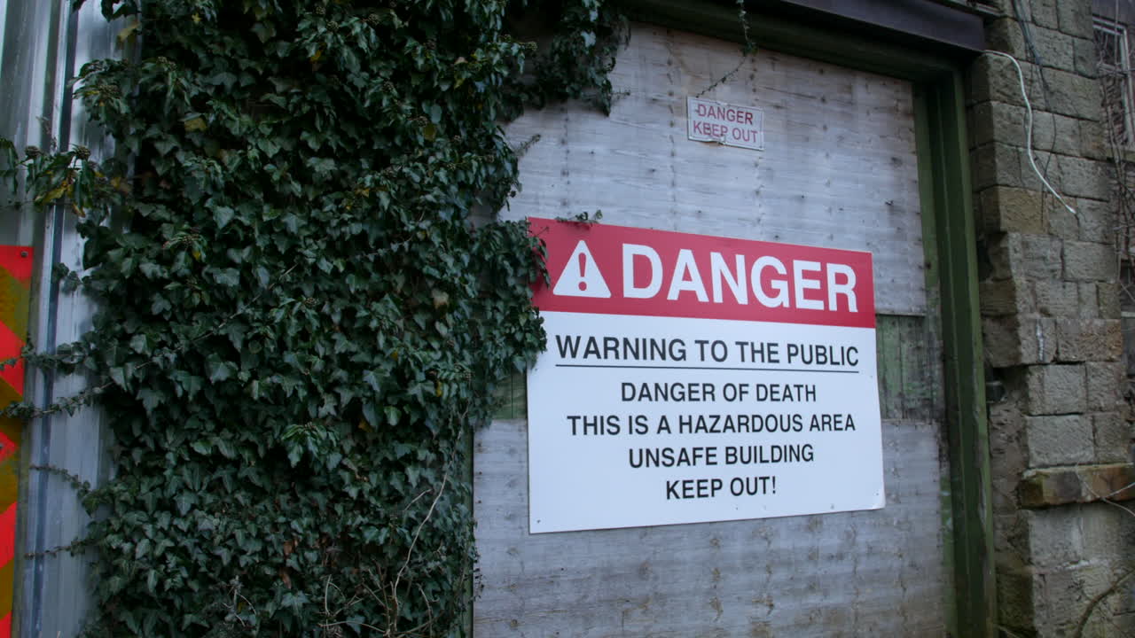 A danger sign on a derelict abandoned building