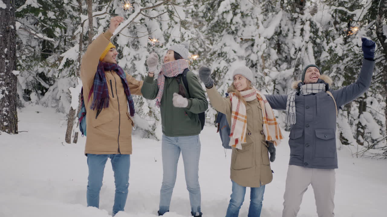Friends Having Fun in the Snowy Forest with Sparkler