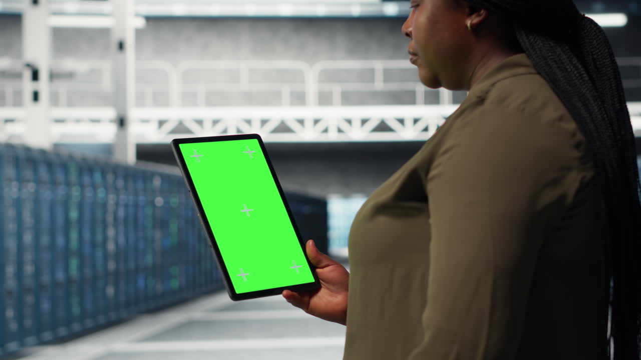 Developer in data center using isolated screen tablet to upgrade systems