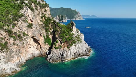 sunlit cliffs and clear blue waters along corfu island's coastline in the ionian sea, aerial view