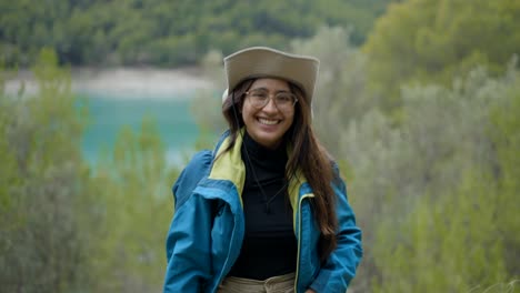 happy woman hiking by a lake