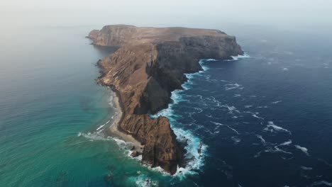 spectacular volcanic island ilhéu da cal surrounded by deep blue ocean water