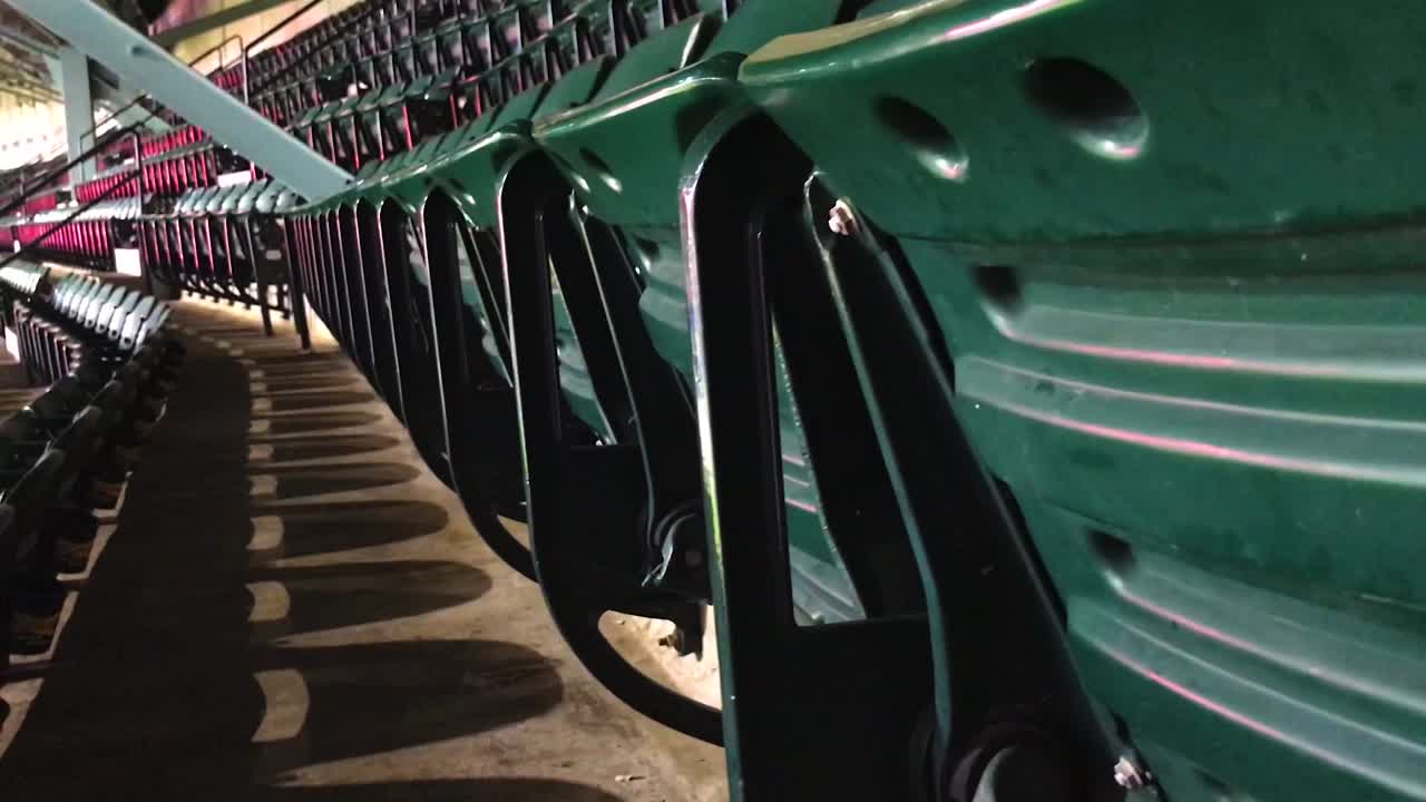 Green chairs in a stadium.