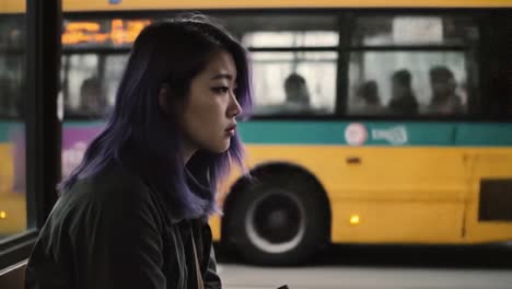 young woman waiting at a bus stop