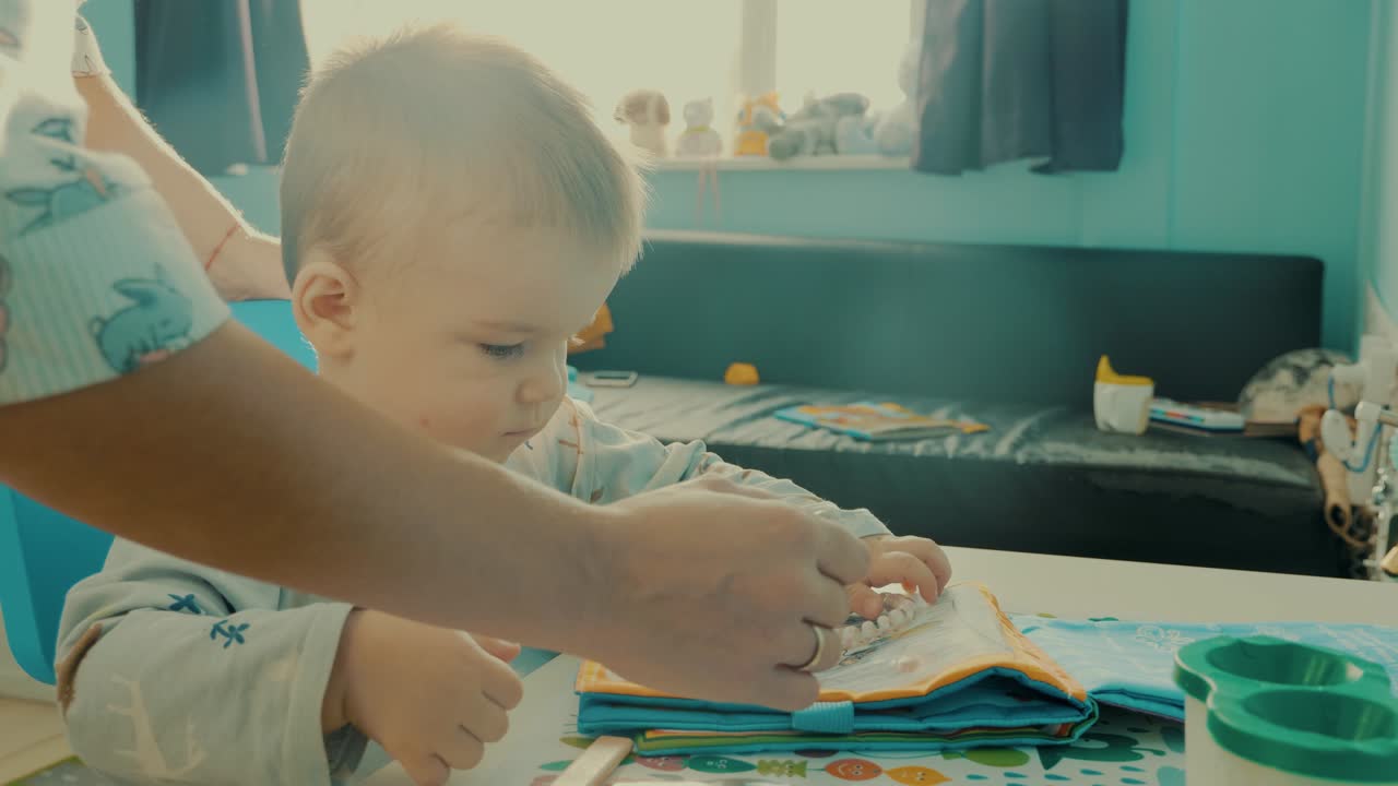 Baby playing with a quiet book