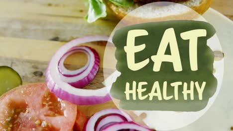 animation of eat healthy text over burger and sliced vegetables on kitchen counter