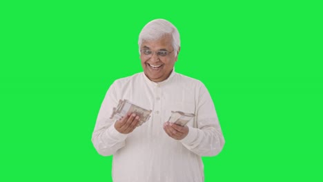 Cheerful-Indian-old-man-counting-money-Green-screen