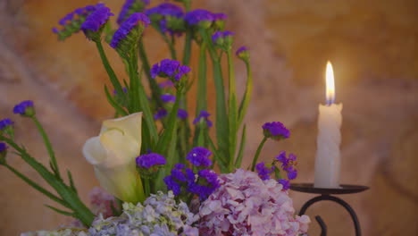 flowers blooming in soft candle light with stone wall