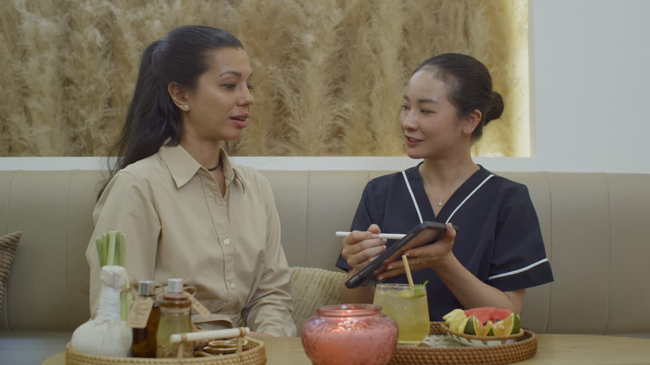 Young Woman Asking Female Admin about Procedure at Beauty Center