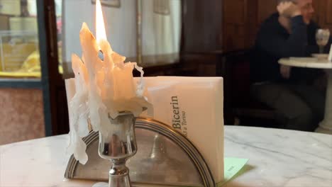 melted candle burning inside the ancient room of caffè al bicerin in turin