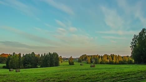 timelapse of colourful clouds moving in blue sky over rural countryside