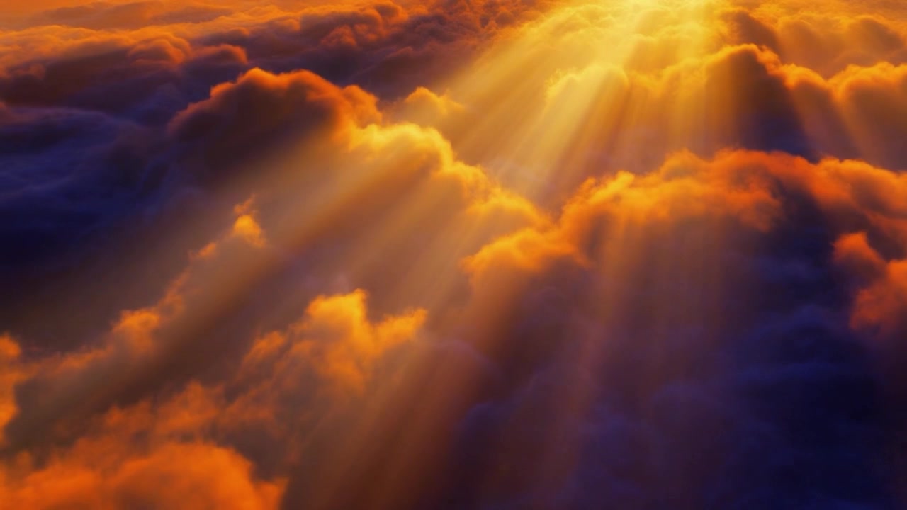 Aerial View of Golden Sunlight Streaming Through Clouds