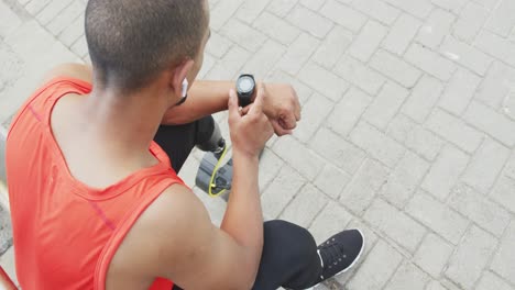 Side-view-man-with-prosthetic-leg-looking-at-his-watch