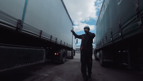 worker directing semi-trucks in a logistics yard