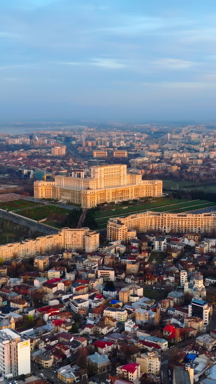 Vertical aerial drone view of Palace of the Parliament in Bucharest downtown at sunset. Romania