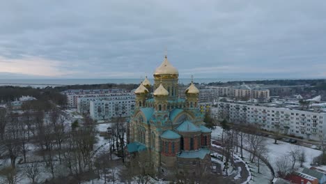 Aerial-establishing-view-of-orthodox-,-distant-wide-drone-shot-moving-backward