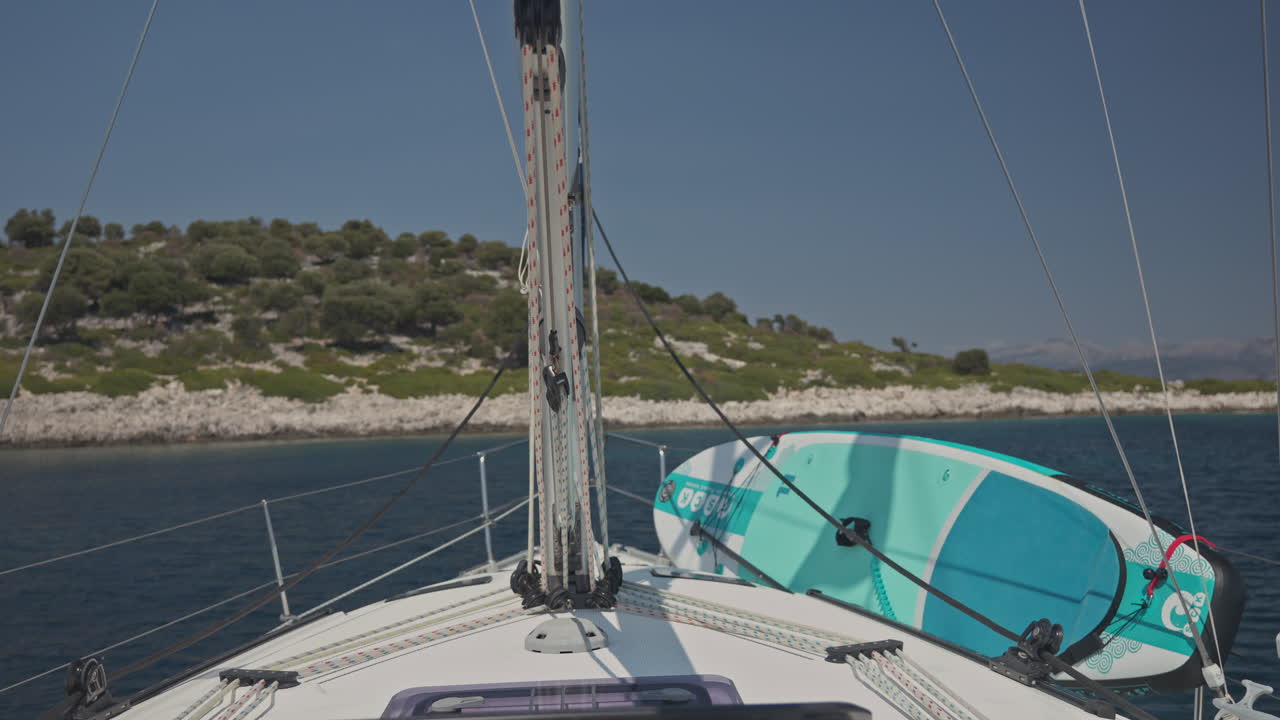 view from a yacht of a greek island at sunrise