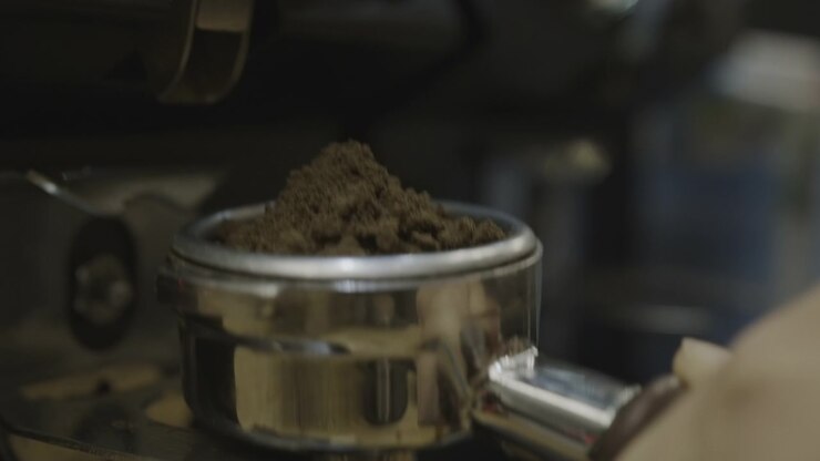 Close up shot of a coffee grinder making fine powder in slowmotion LOG