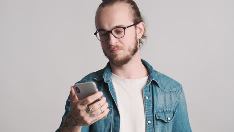 caucasian young man taking selfies on smartphone.