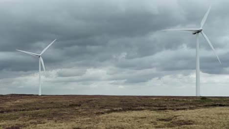 drone aerial video of a wind farm and wind turbines turning in the wind