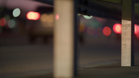 Dark-city-highway-guardrail-iron-beam-closeup.-Metallic-part-reflect-headlights