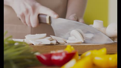 chopping mushrooms and vegetables for cooking