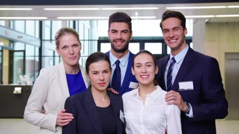 smiling businesspeople standing together in office