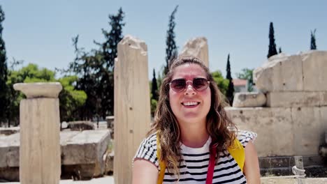 smiling woman's selfie among ancient acropolis ruins, athens, greece