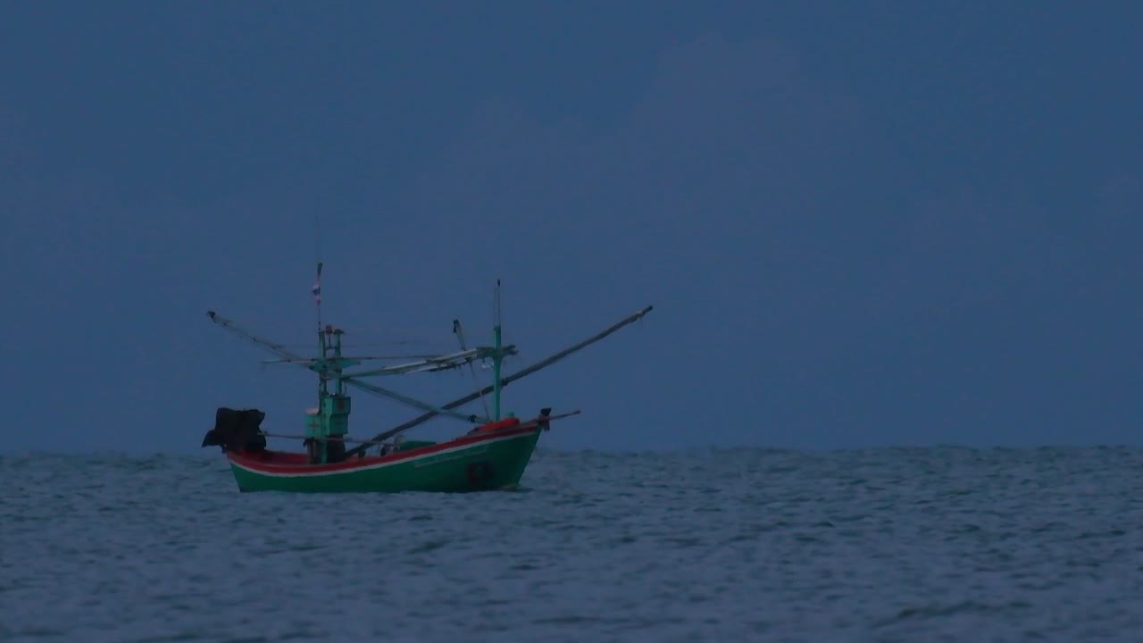 태국의 어선은 바다 한가운데서 어두워지기를 기다리며 초록불을 켜고 낚시를 시작하고 새우를 잡습니다.
