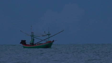 los barcos de pesca en tailandia esperan en medio del océano a que oscurezca para poder encender sus luces verdes y comenzar a pescar y pescar camarones