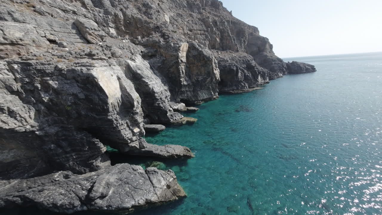First Person View of turquoise water and stunning rock formations of Aspes Black Beach, South Crete, Greece