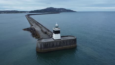 holyhead breakwater lighthouse longest concrete coastal sea protection landmark aerial descending forward view