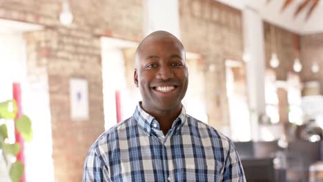 portrait of happy african american casual businessman in creative office in slow motion