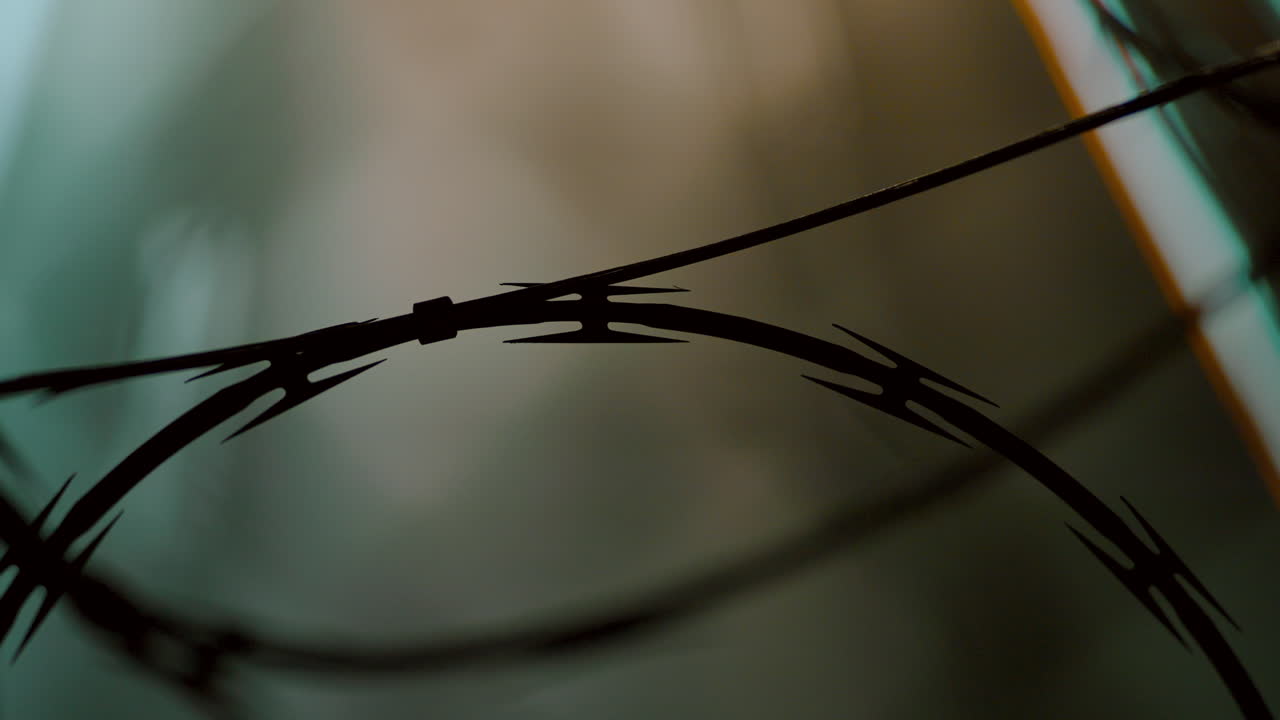 Abstract Time-Lapse of Freeway Traffic with Barbed Wire in the Foreground