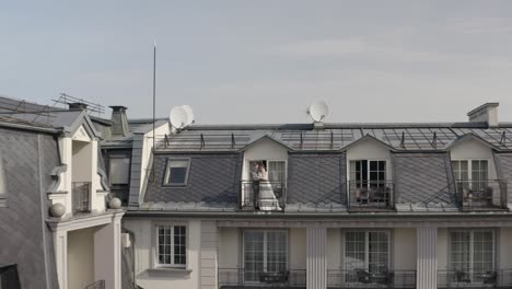 caucasian newlyweds bride embracing groom on balcony in hotel room, aerial view