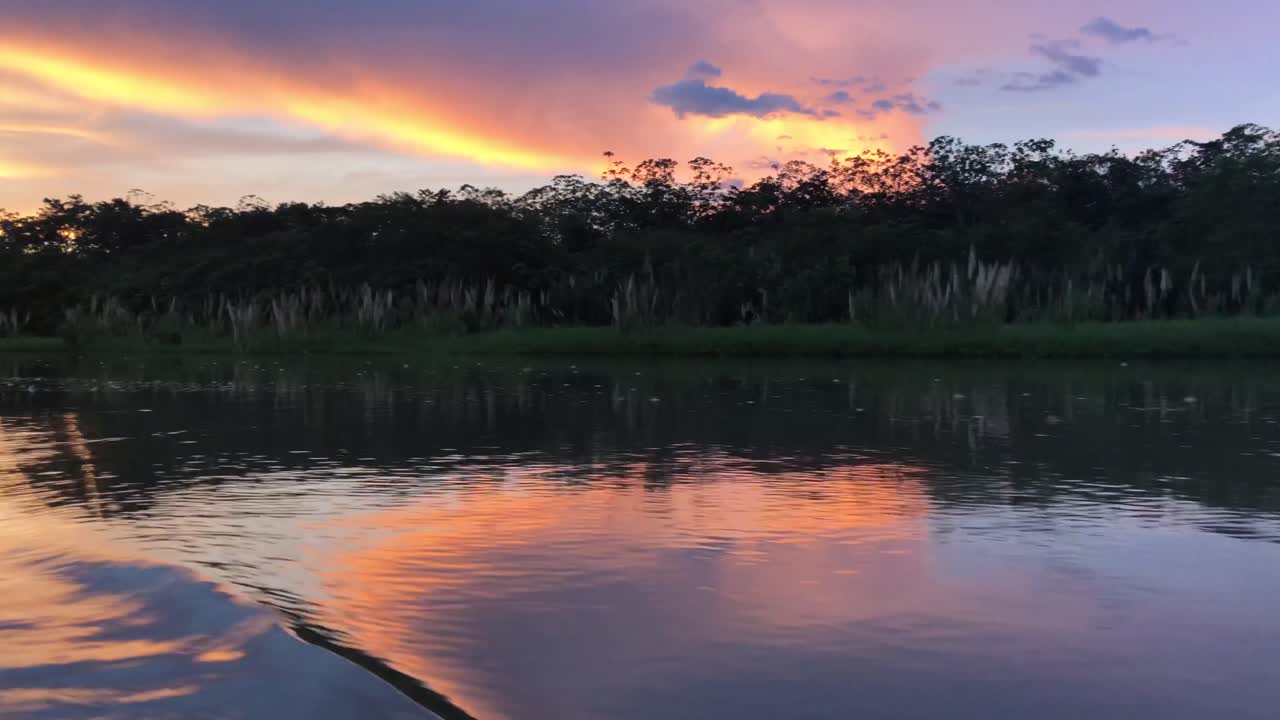 Sunset in Amazonas from a canoe, with nice clouds. Sailing during the sunset with a canoe on the amazon river.