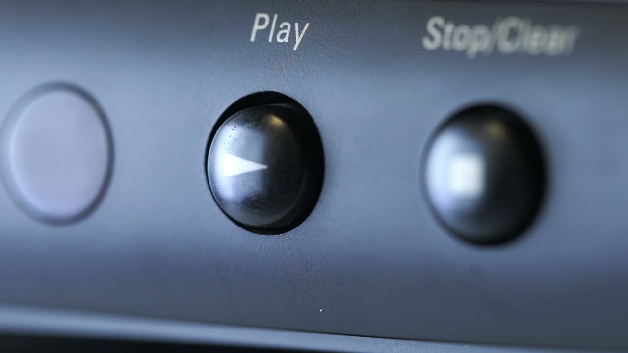 registratore di nastro in primo piano, un uomo preme i pulsanti