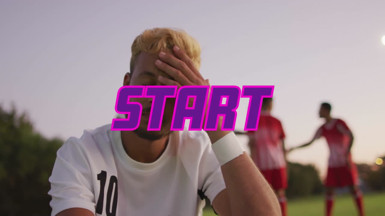 Sitting on field, man in sports jersey with animation of START text