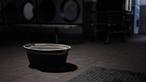 a rusty metal bucket in a laundry room