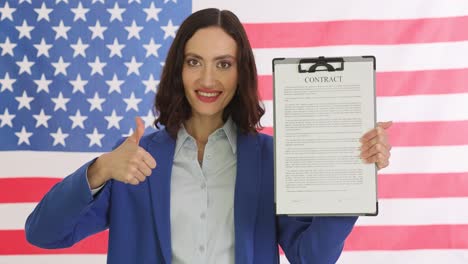 woman with american flag and contract document giving thumbs up