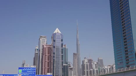 burj khalifa and downtown dubai skyscrapers and towers, view from highway and moving vehicle