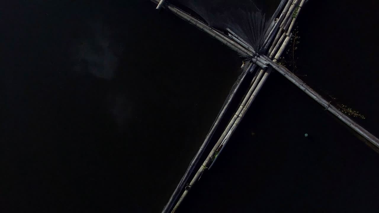 Bamboo hut structure for local aquaculture provide domestic food needs of small rural farming community in Sampaloc Lake, Laguna. drone, aerial shot